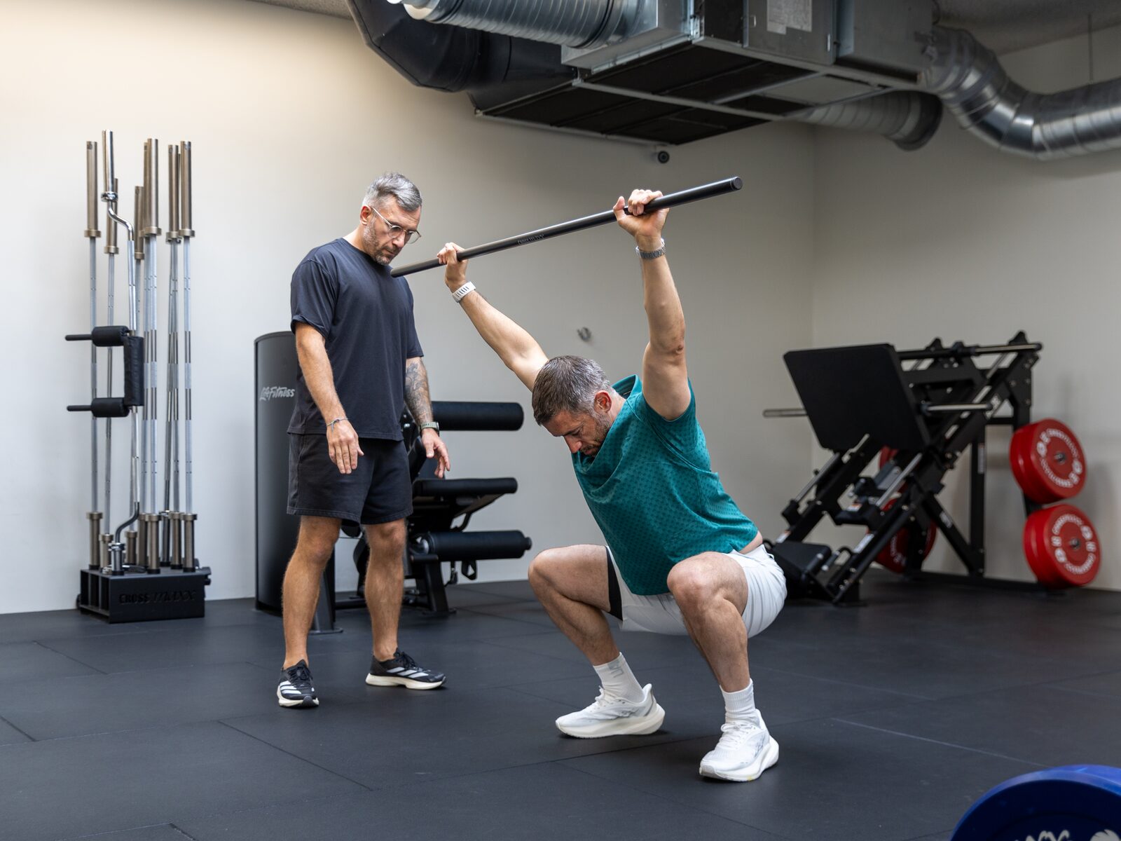 Ben coaching a client through an overhead squat